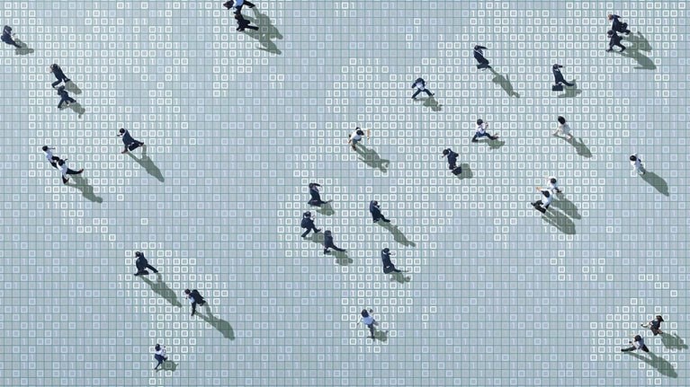 Businessmen walking on binary code world map