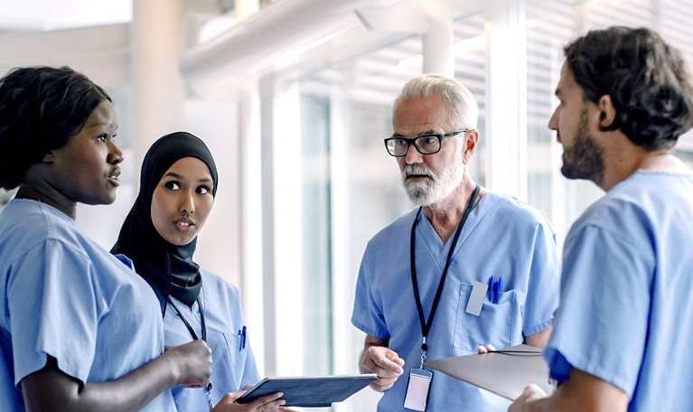 Image of a diverse group of nurses talking in a hospital.
