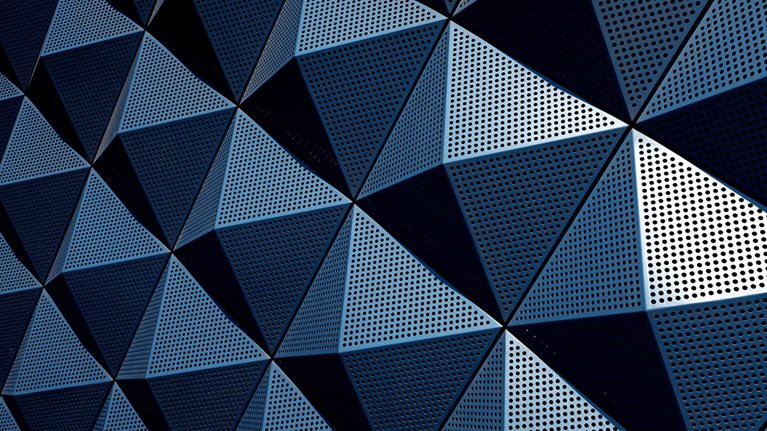 A wall composed of repeating metal pyramids