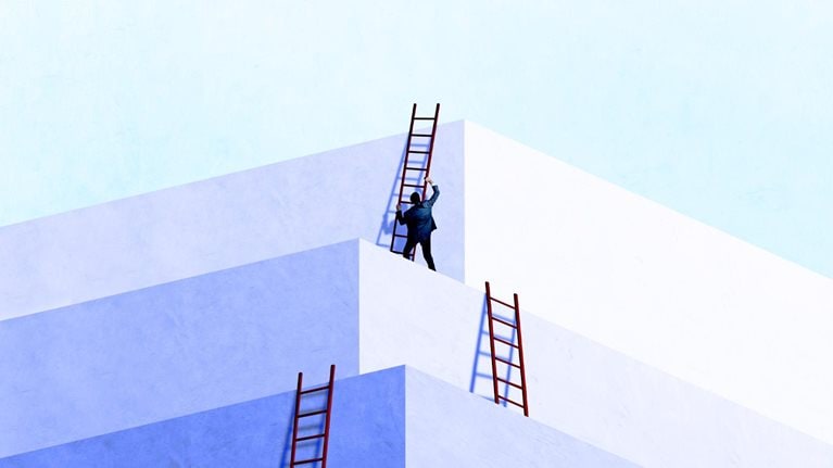 A person in business attire climbing a red ladder positioned against a series of large, white geometric blocks arranged like stepped platforms.