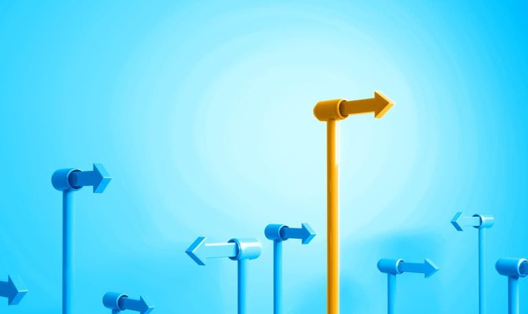 A field of blue directional arrows, all pointing in various directions, with one bright yellow arrow that stands above the rest.