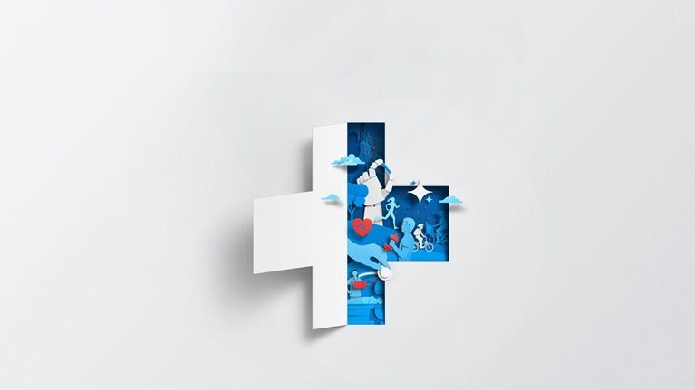A white sheet of paper has been cut and folded in half, creating the silhouette of a medical cross. The empty space left by the folded paper is filled with blue and red shapes that show health and well-being. Some shapes include exercise, family activities, and medical care.