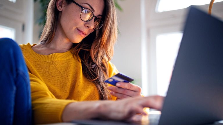 A young woman shopping online paying with credit card