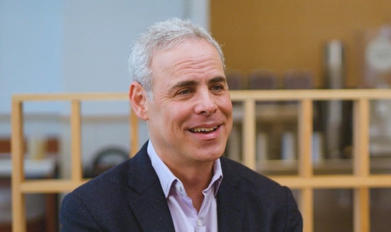 Image of Brett Schulman smiling during an interview.