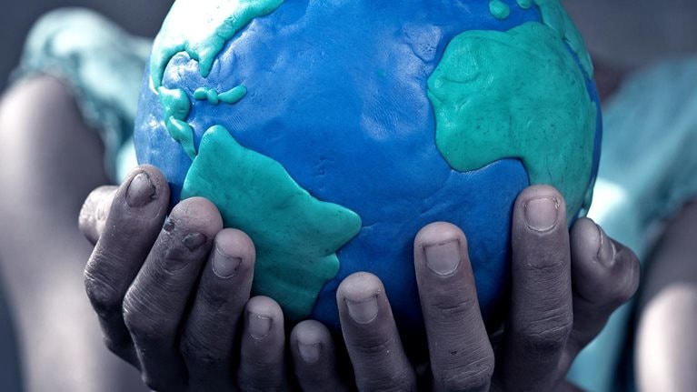 Young girl holding a globe in her hands