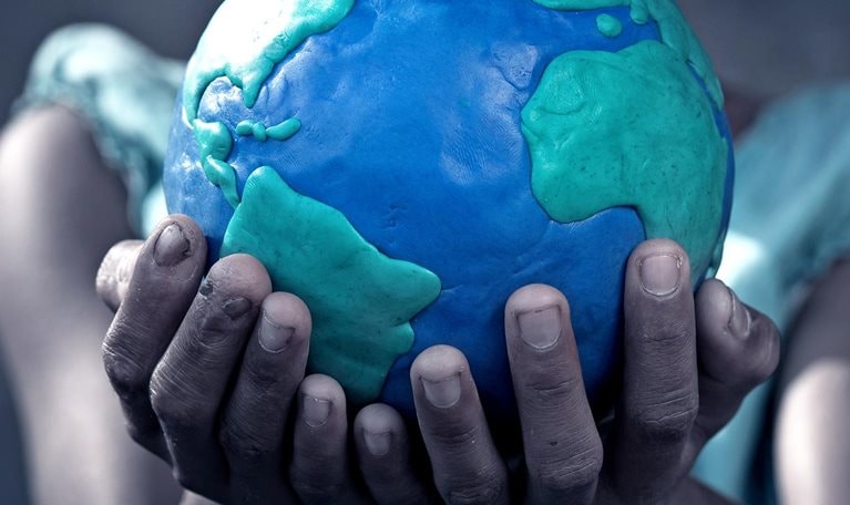 Young girl holding a globe in her hands