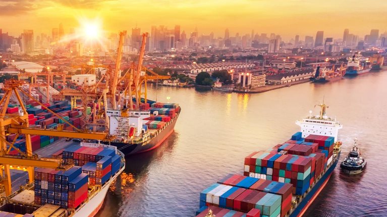 Logistics and transportation of Container Cargo ship and Cargo plane with working crane bridge in shipyard at sunrise