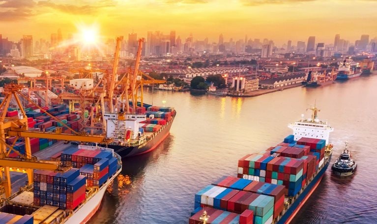 Logistics and transportation of Container Cargo ship and Cargo plane with working crane bridge in shipyard at sunrise