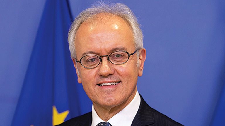  Portrait of Marco Buti photographed in front of a United Nation flag.