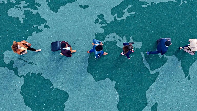 Businesspeople walking in line across world map painted on asphalt