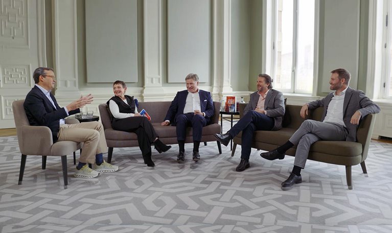 Chris Bradley, Nick Leung, Sven Smit, Janet Bush, and Marc Canal sitting and talking together.