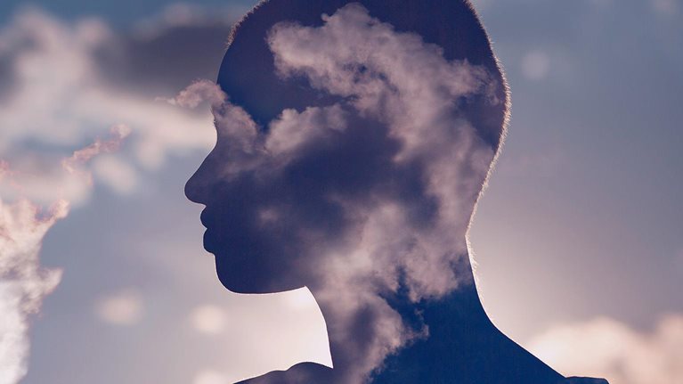 Photo illustration of a woman's silhouette enhanced by clouds