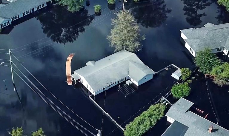 Homes surrounded by flood water in South Carolina after a hurricane.